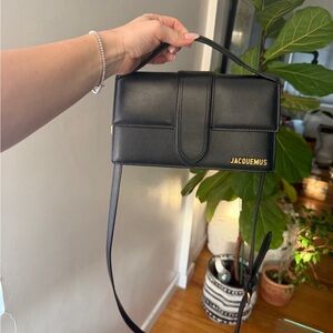 Jacquemus Le Grand Bambino Black Leather Bag with adjustable crossbody strap.